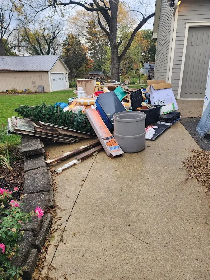 Dumpster being loaded with debris for 10 Yard Dumpster Rental in Stanford